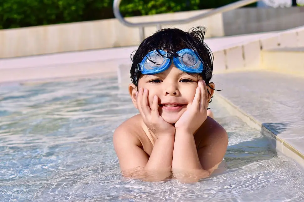 Child swimming with coach - why kids should learn to swim